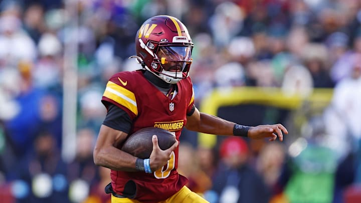 Dec 22, 2024; Landover, Maryland, USA; Washington Commanders quarterback Jayden Daniels (5) runs the ball during the third quarter against the Philadelphia Eagles at Northwest Stadium. Mandatory Credit: Peter Casey-Imagn Images