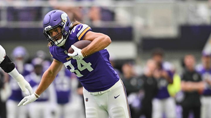 Aug 26, 2023; Minneapolis, Minnesota, USA; Minnesota Vikings tight end Nick Muse (34) runs the ball after a pass reception as Arizona Cardinals safety Jovante Moffatt (38) makes the tackle and linebacker Cameron Thomas (97) moves in during the first quarter at U.S. Bank Stadium.