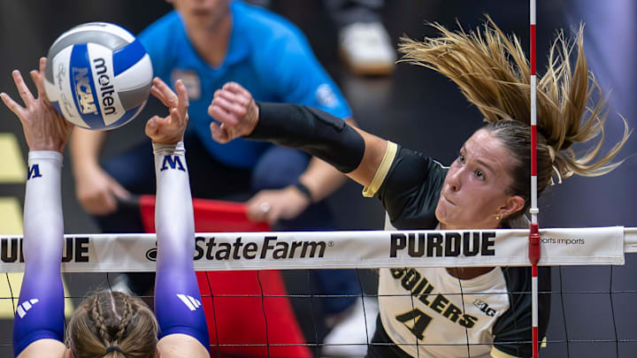 Purdue Junior Kenna Wollard (4) smashes the ball through for a point Purdue Junior Kenna Wollard (4) smashes the ball through for a point