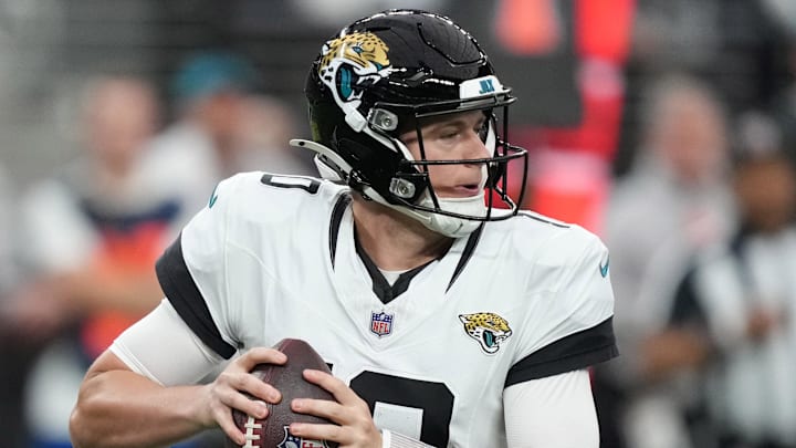 Dec 22, 2024; Paradise, Nevada, USA; Jacksonville Jaguars quarterback Mac Jones (10) scrambles against the Las Vegas Raiders in the first half at Allegiant Stadium. Mandatory Credit: Kirby Lee-Imagn Images