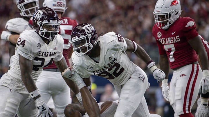 Texas A&M Aggies linebacker Chris Russell Jr. (24) and defensive lineman Malick Sylla (92) celebrate a sack of Arkansas Razorbacks quarterback KJ Jefferson (1) during the second half at AT&T Stadium. Texas A&M Aggies linebacker Chris Russell Jr. (24) and defensive lineman Malick Sylla (92) celebrate a sack of Arkansas Razorbacks quarterback KJ Jefferson (1) during the second half at AT&T Stadium.