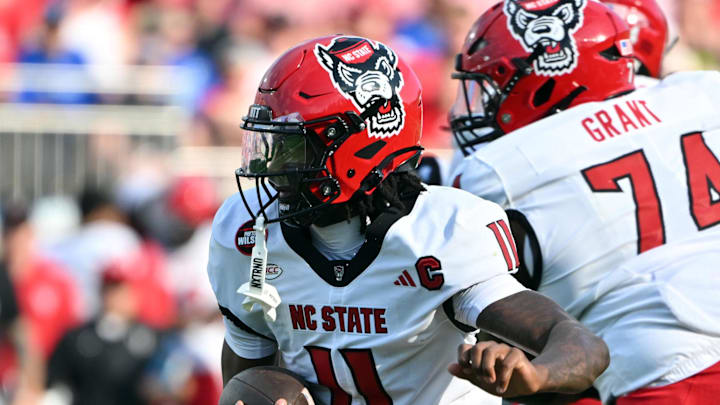 Sep 20, 2025; Durham, North Carolina, USA;  North Carolina State Wolfpack quarter back CJ Bailey (11) runs the ball against the Duke Blue Devils during the first quarter at Wallace Wade Stadium. Mandatory Credit: Zachary Taft-Imagn Images