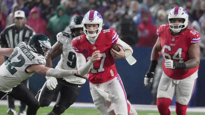 Buffalo Bills quarterback Josh Allen runs with the ball for several yards before being tripped up by Philadelphia Eagles linebacker Jalyx Hunt at Highmark Stadium in Orchard Park on Dec. 28, 2025.