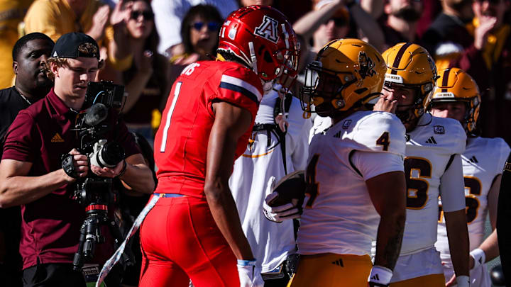 Nov 30, 2024; Tucson, Arizona, USA; Arizona Wildcats defensive back Tacario Davis (1) gets in the face of Arizona State Sun Devils running back Cam Skattebo (4) during the first quarter at Arizona Stadium Nov 30, 2024; Tucson, Arizona, USA; Arizona Wildcats defensive back Tacario Davis (1) gets in the face of Arizona State Sun Devils running back Cam Skattebo (4) during the first quarter at Arizona Stadium