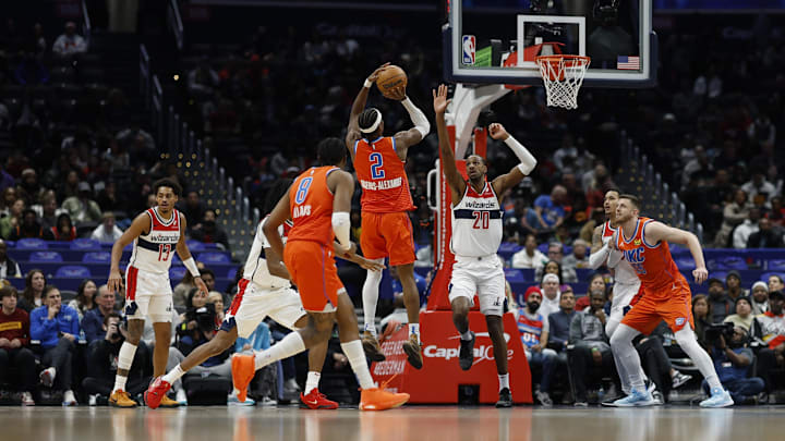 Jan 12, 2025; Washington, District of Columbia, USA; Oklahoma City Thunder guard Shai Gilgeous-Alexander (2) shoots the ball as Washington Wizards forward Alexandre Sarr (20) defends in the first quarter at Capital One Arena. Mandatory Credit: Geoff Burke-Imagn Images