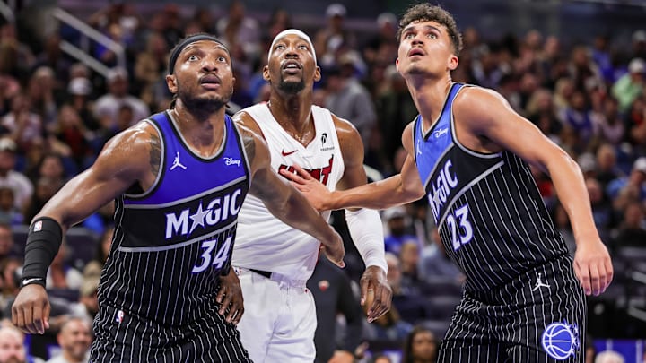 Dec 9, 2025; Orlando, Florida, USA; Orlando Magic center Wendell Carter Jr. (34), forward Tristan da Silva (23) and Miami Heat center Bam Adebayo (13) look for the rebound  during the second quarter at Kia Center. Mandatory Credit: Mike Watters-Imagn Images
