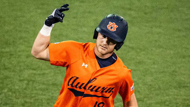 Auburn Tigers catcher Ike Irish (18) celebrates with associate coach Karl Nonemaker (35) as he rounds third base to head home in the seventh inning as the Longhorns play the Auburn Tigers in the second game of a three-game series on Friday night at UFCU Disch-Falk Field in Austin, April 18, 2025.
