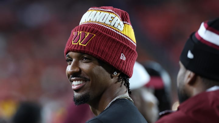Aug 18, 2025; Landover, Maryland, USA; Washington Commanders quarterback Jayden Daniels (5) looks on from the sidelines during the second half against the Cincinnati Bengals at Northwest Stadium. Mandatory Credit: Amber Searls-Imagn Images