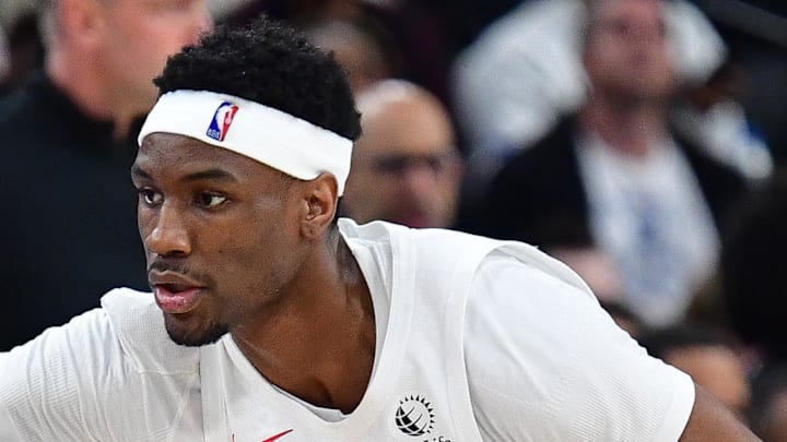 Los Angeles Clippers guard Kris Dunn moves the ball against Toronto Raptors guard Ja'kobe Walter. Los Angeles Clippers guard Kris Dunn moves the ball against Toronto Raptors guard Ja'kobe Walter.