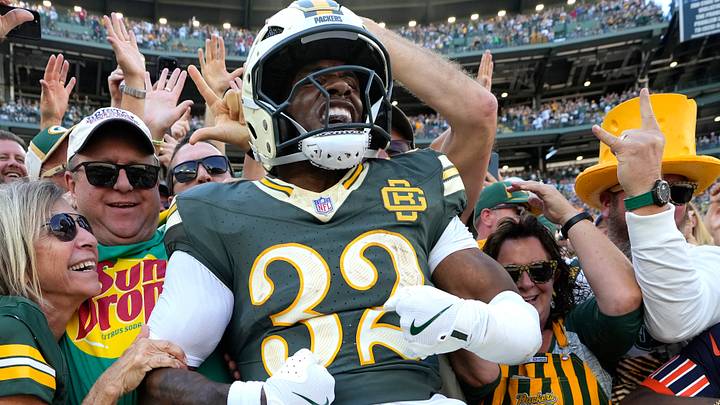Green Bay Packers running back Marshawn Lloyd (32) celebrates scoring a touchdown with a Lambeau Leap vs. the Bears.