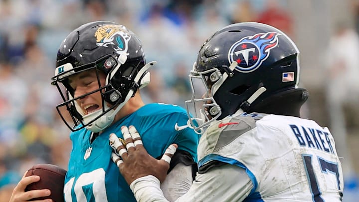 Jacksonville Jaguars quarterback Mac Jones is forced out of bounds by Tennessee Titans linebacker Jerome Baker.