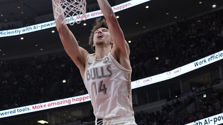 Mar 29, 2025; Chicago, Illinois, USA; Chicago Bulls forward Matas Buzelis (14) dunks the ball against Dallas Mavericks forward Kai Jones (23) during the first half at United Center. Mandatory Credit: David Banks-Imagn Images