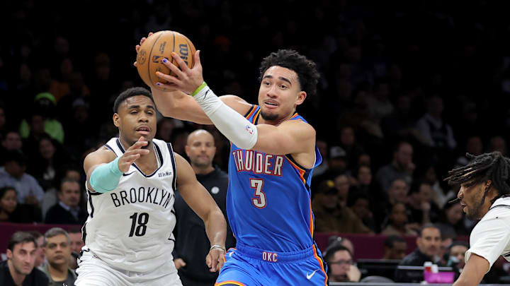 Mar 18, 2026; Brooklyn, New York, USA; Oklahoma City Thunder guard Jared McCain (3) drives to the basket against Brooklyn Nets guard Malachi Smith (18) and forward Ziaire Williams (1) during the first quarter at Barclays Center. Mandatory Credit: Brad Penner-Imagn Images
