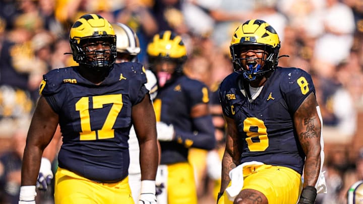 Michigan edge Derrick Moore (8) celebrates a sack against Washington quarterback Demond Williams Jr. (2) during the first half at Michigan Stadium in Ann Arbor on Saturday, Oct. 18, 2025.
