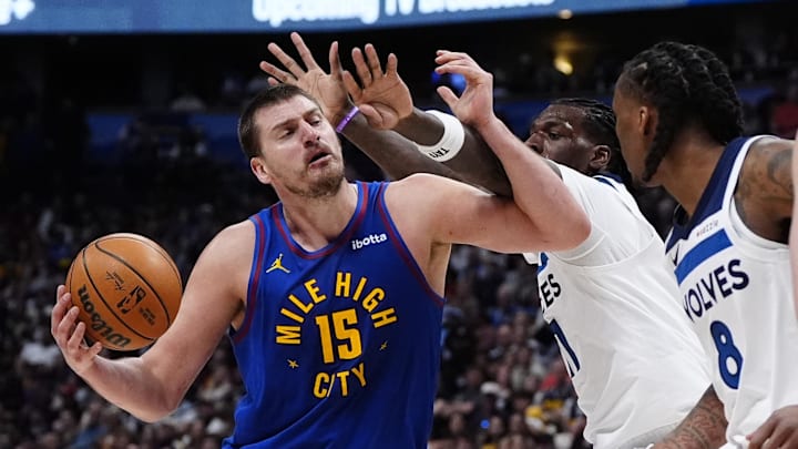 Mar 1, 2026; Denver, Colorado, USA; Minnesota Timberwolves center Naz Reid (11) defends on Denver Nuggets center Nikola Jokic (15) in the second half at Ball Arena. Mandatory Credit: Ron Chenoy-Imagn Images