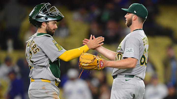 May 13, 2025; Los Angeles, California, USA; Athletics catcher Shea Langeliers (23) and pitcher Justin Sterner (60) celebrate the victory against the Los Angeles Dodgers at Dodger Stadium. Mandatory Credit: Gary A. Vasquez-Imagn Images