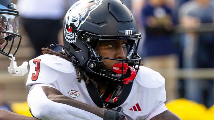 Oct 11, 2025; South Bend, Indiana, USA; NC State Wolfpack quarterback CJ Bailey (11) hands off to NC State Wolfpack running back Hollywood Smothers (3) during the first half at Notre Dame Stadium. Mandatory Credit: Michael Caterina-Imagn Images