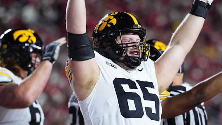 Oct 11, 2025; Madison, Wisconsin, USA; Iowa Hawkeyes offensive lineman Logan Jones (65) celebrates a touchdown in the first half against the Wisconsin Badgers at Camp Randall Stadium. Mandatory Credit: Ross Harried-Imagn Images