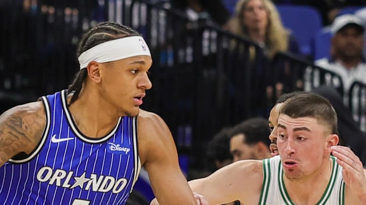 Orlando Magic forward Paolo Banchero drives around Boston Celtics guard Payton Pritchard.