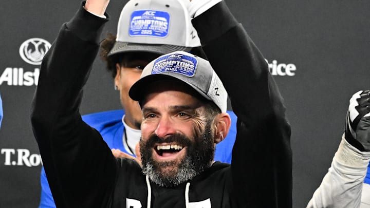 Dec 6, 2025; Charlotte, NC, USA; Duke Blue Devils head coach Manny Diaz lifts the ACC trophy with offensive lineman Justin Pickett (77) and defensive tackle Aaron Hall (99) after defeating the Virginia Cavaliers at the 2025 ACC Championship game at Bank of America Stadium. Mandatory Credit: Bob Donnan-Imagn Images Dec 6, 2025; Charlotte, NC, USA; Duke Blue Devils head coach Manny Diaz lifts the ACC trophy with offensive lineman Justin Pickett (77) and defensive tackle Aaron Hall (99) after defeating the Virginia Cavaliers at the 2025 ACC Championship game at Bank of America Stadium. Mandatory Credit: Bob Donnan-Imagn Images