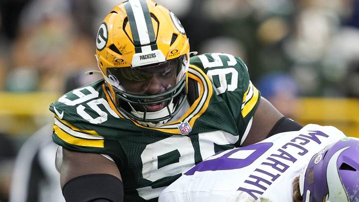 Minnesota Vikings quarterback J.J. McCarthy (9) is sacked by. Green Bay Packers defensive tackle Devonte Wyatt.