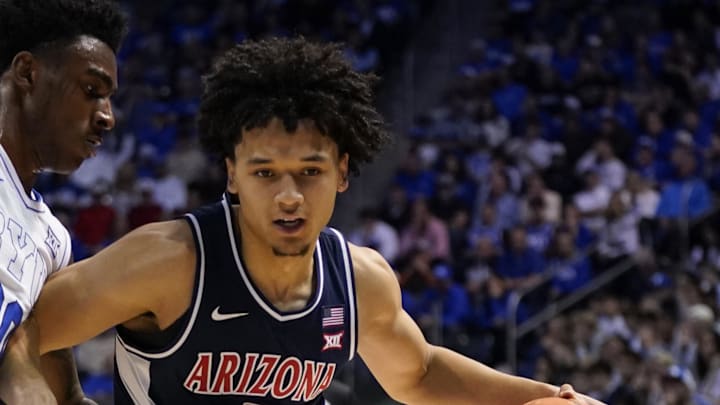 Jan 26, 2026; Provo, Utah, USA; Arizona Wildcats guard Brayden Burries (5) controls the ball while being defended by BYU Cougars forward Kennard Davis Jr. (30) during the second half at Marriott Center. Mandatory Credit: Aaron Baker-Imagn Images 
