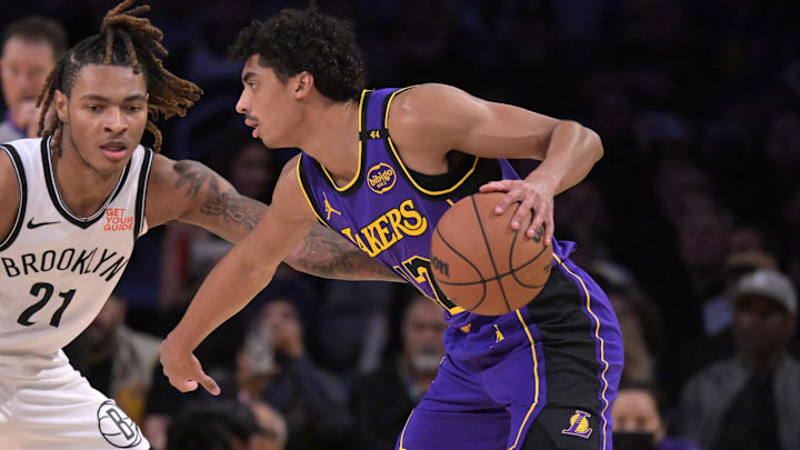Jan 17, 2025; Los Angeles, California, USA;  Los Angeles Lakers guard Max Christie (12) controls the ball away from Brooklyn Nets forward Noah Clowney (21) in the first half at Crypto.com Arena. Mandatory Credit: Jayne Kamin-Oncea-Imagn Images
