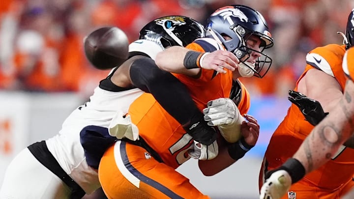 Dec 21, 2025; Denver, Colorado, USA; Jacksonville Jaguars defensive end Travon Walker (44) hits Denver Broncos quarterback Bo Nix (10) during the second half at Empower Field at Mile High. 