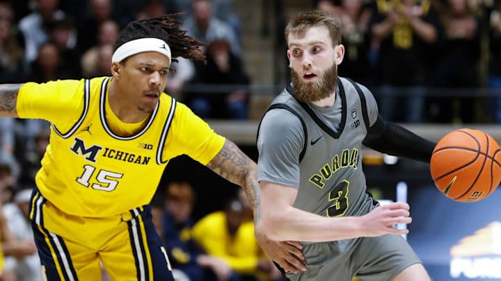 Michigan Wolverines guard Rubin Jones (15) defends Purdue Boilermakers guard Braden Smith 