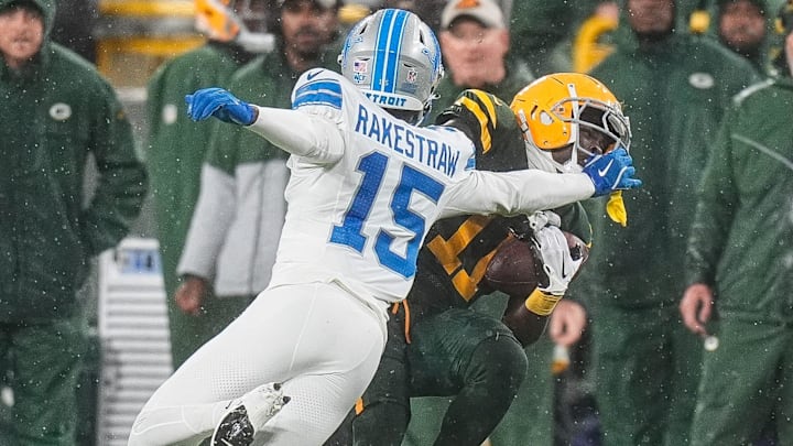 Detroit Lions cornerback Ennis Rakestraw Jr. (15) tackles Green Bay Packers wide receiver Jayden Reed (11) 