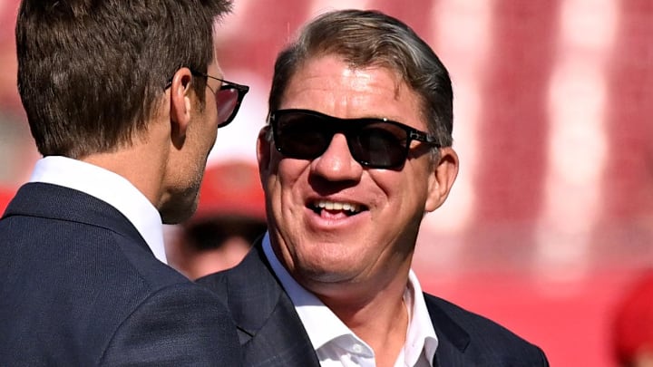 Jan 5, 2025; Tampa, Florida, USA; Fox Sports color commentator Tom Brady talks with Tampa Bay Buccaneers GM Jason Licht before the start of the game between the Tampa Bay Buccaneers and New Orleans Saints at Raymond James Stadium. Mandatory Credit: Jonathan Dyer-Imagn Images Jan 5, 2025; Tampa, Florida, USA; Fox Sports color commentator Tom Brady talks with Tampa Bay Buccaneers GM Jason Licht before the start of the game between the Tampa Bay Buccaneers and New Orleans Saints at Raymond James Stadium. Mandatory Credit: Jonathan Dyer-Imagn Images