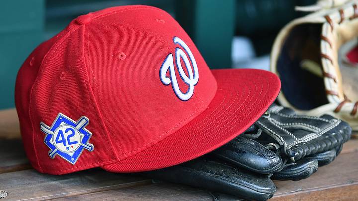 Red Washington Nationals hat on top of a black mitt
