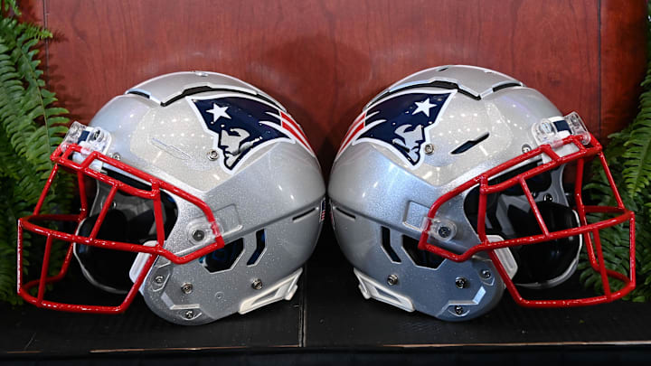 Jan 13, 2025; Foxborough, MA, USA; A pair of New England Patriots helmets sit in front of the podium before a press conference at Gillette Stadium. Mandatory Credit: Eric Canha-Imagn Images Jan 13, 2025; Foxborough, MA, USA; A pair of New England Patriots helmets sit in front of the podium before a press conference at Gillette Stadium. Mandatory Credit: Eric Canha-Imagn Images