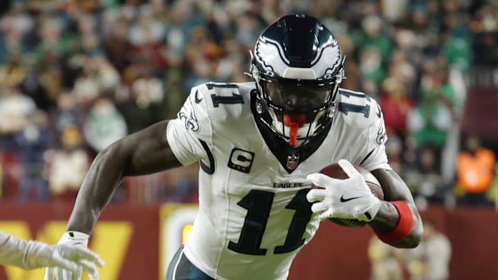 Dec 20, 2025; Landover, Maryland, USA; Philadelphia Eagles wide receiver A.J. Brown (11) carries the ball as Washington Commanders cornerback Jonathan Jones (31) defends during the first half at Northwest Stadium. Mandatory Credit: Amber Searls-Imagn Images