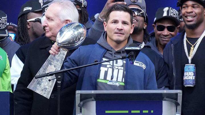 Feb 11, 2026; Seattle, WA, USA; Seattle Seahawks head coach Mike MacDonald holds the Vince Lombardi trophy  as general manager John Schneider watches during the Super Bowl LX trophy celebration at Lumen Field. Mandatory Credit: Kirby Lee-Imagn Images