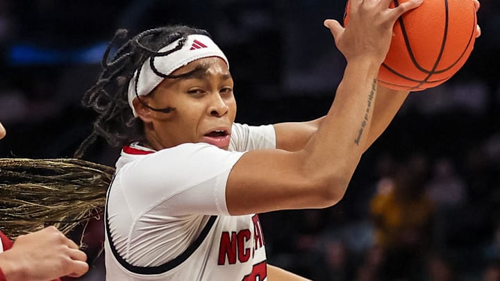 Nov 9, 2025; Charlotte, North Carolina, USA;  NC State Wolfpack guard Zoe Brooks (35) battles for the ball against the Southern California Trojans during the first quarter of the Ally Tipoff game at Spectrum Center. Mandatory Credit: Cory Knowlton-Imagn Images