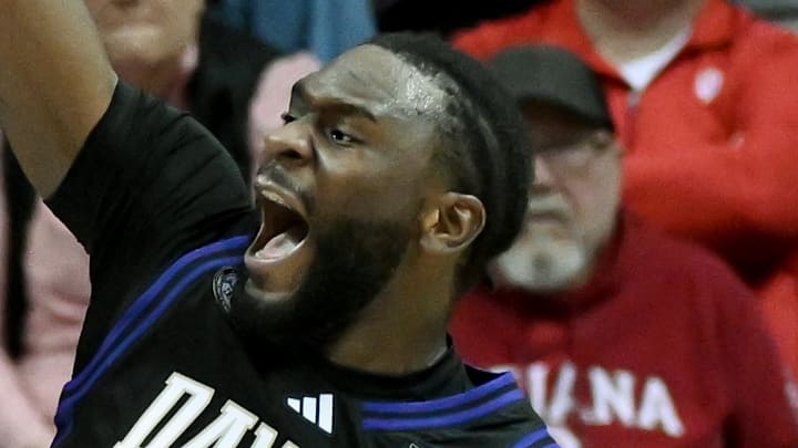Jan 4, 2026; Bloomington, Indiana, USA; Washington Huskies center Franck Kepnang (11) dunks the ball against Indiana Hoosiers forward Reed Bailey (1) during the first half at Simon Skjodt Assembly Hall.