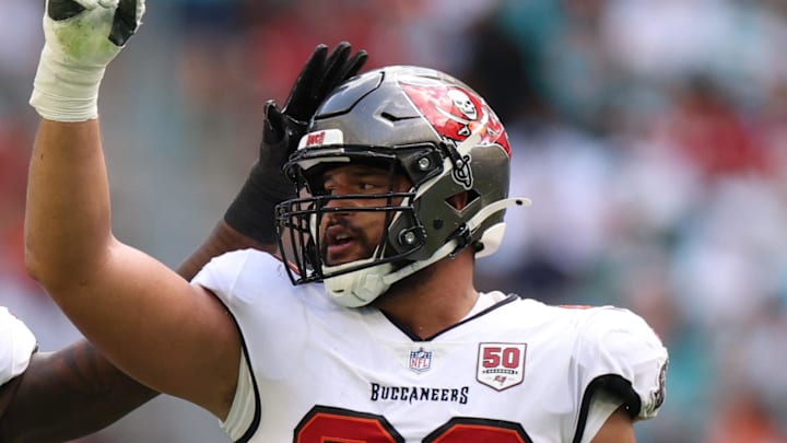 Tampa Bay Buccaneers defensive end Logan Hall (90) celebrates with linebacker Lavonte David (54) 
