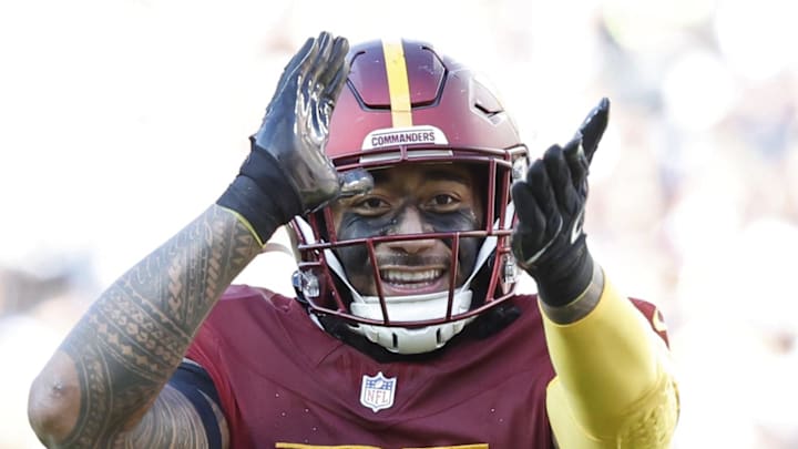 Nov 24, 2024; Landover, Maryland, USA; Washington Commanders linebacker Frankie Luvu (4) gestures to fans in the stands after making a tackle against the Dallas Cowboys at Northwest Stadium. Mandatory Credit: Geoff Burke-Imagn Images