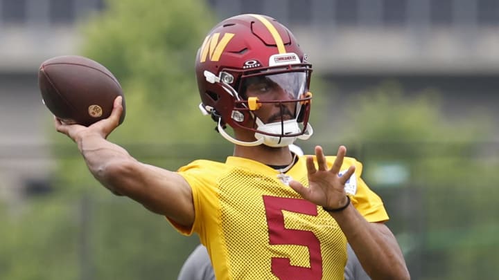 Jun 5, 2024; Ashburn, VA, USA; Washington Commanders quarterback Jayden Daniels (5) prepares to pass a ball during an OTA workout at Commanders Park. Mandatory Credit: Geoff Burke-USA TODAY Sports