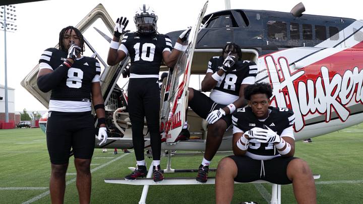 Nebraska football recruits pose with a Huskers-branded helicopter during their official visit. Nebraska football recruits pose with a Huskers-branded helicopter during their official visit.