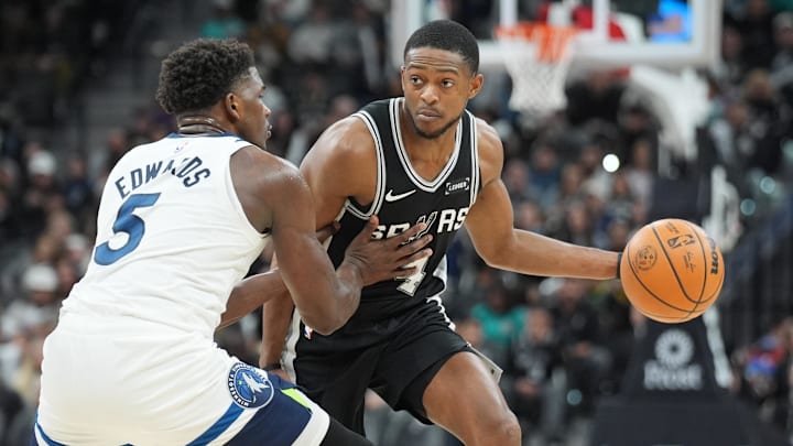 Jan 17, 2026; San Antonio, Texas, USA; San Antonio Spurs guard De'Aaron Fox (4) dribbles against Minnesota Timberwolves guard Anthony Edwards (5) in the second half at Frost Bank Center.