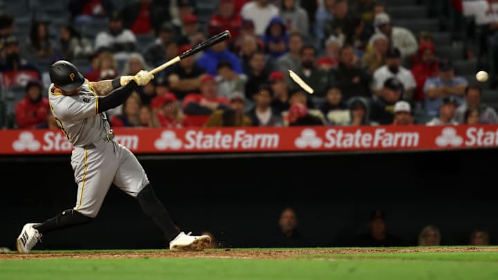 Apr 23, 2025; Anaheim, California, USA;  Pittsburgh Pirates left fielder Tommy Pham (28) hits an RBI single during the ninth inning against the Los Angeles Angels at Angel Stadium.