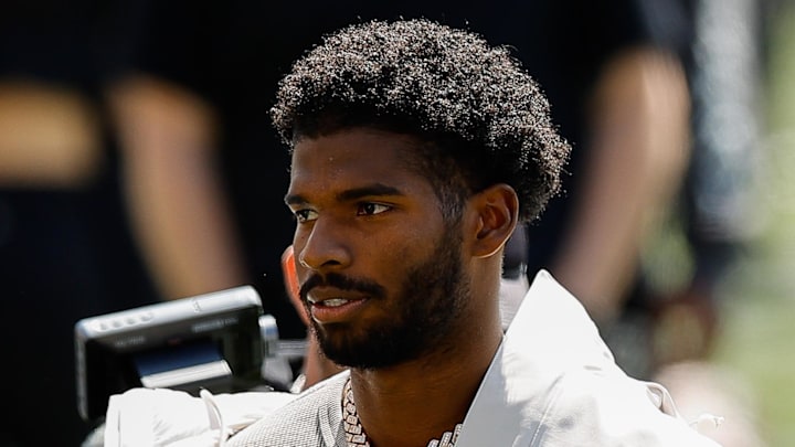 Former Colorado Buffaloes quarterback Shedeur Sanders watches his jersey be retired.