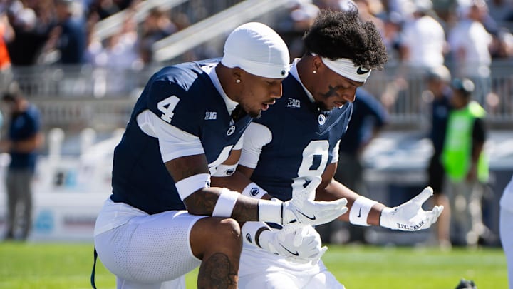 Penn State defensive players on their knees