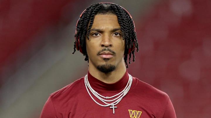 Jan 12, 2025; Tampa, Florida, USA; Washington Commanders quarterback Jayden Daniels (5) warms up before a NFC wild card playoff against the Tampa Bay Buccaneers at Raymond James Stadium. Mandatory Credit: Nathan Ray Seebeck-Imagn Images