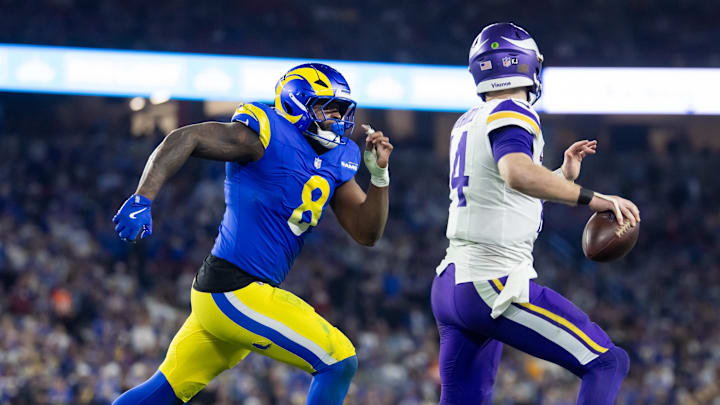 Jan 13, 2025; Glendale, AZ, USA; Minnesota Vikings quarterback Sam Darnold (14) is pursued by Los Angeles Rams linebacker Jared Verse (8) during an NFC wild card game at State Farm Stadium. Mandatory Credit: Mark J. Rebilas-Imagn Images Jan 13, 2025; Glendale, AZ, USA; Minnesota Vikings quarterback Sam Darnold (14) is pursued by Los Angeles Rams linebacker Jared Verse (8) during an NFC wild card game at State Farm Stadium. Mandatory Credit: Mark J. Rebilas-Imagn Images