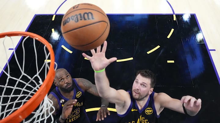 Mar 3, 2026; Los Angeles, California, USA; Los Angeles Lakers guard Luka Doncic (77) and forward LeBron James (23) rebound the ball against the New Orleans Pelicans in the second half at Crypto.com Arena. Mandatory Credit: Kirby Lee-Imagn Images