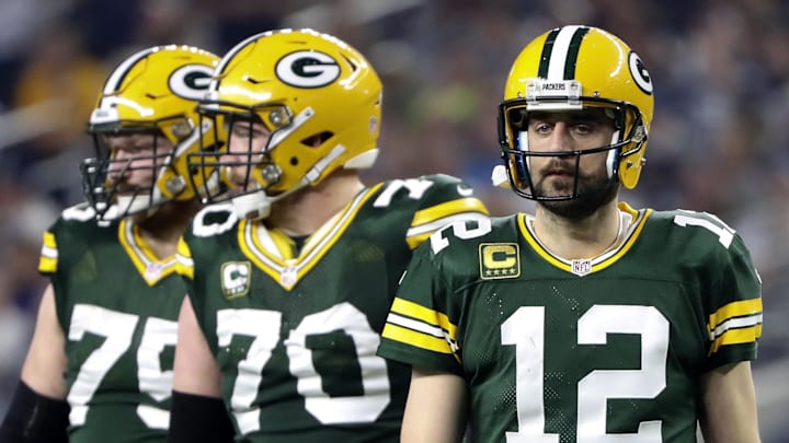 Green Bay Packers quarterback Aaron Rodgers (12) and guard T.J. Lang (70)  in action during the game against Cowboys
