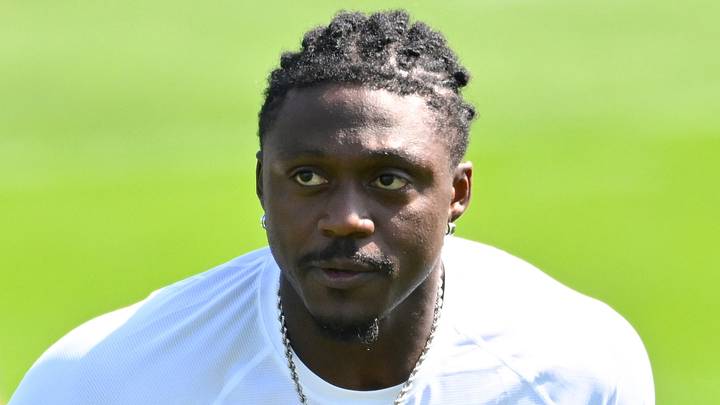Jul 25, 2026; Foxborough, MA, USA; New England Patriots wide receiver A.J. Brown (1) delivers a puppy to its new family at training camp at Gillette Stadium. Mandatory Credit: Eric Canha-Imagn Images